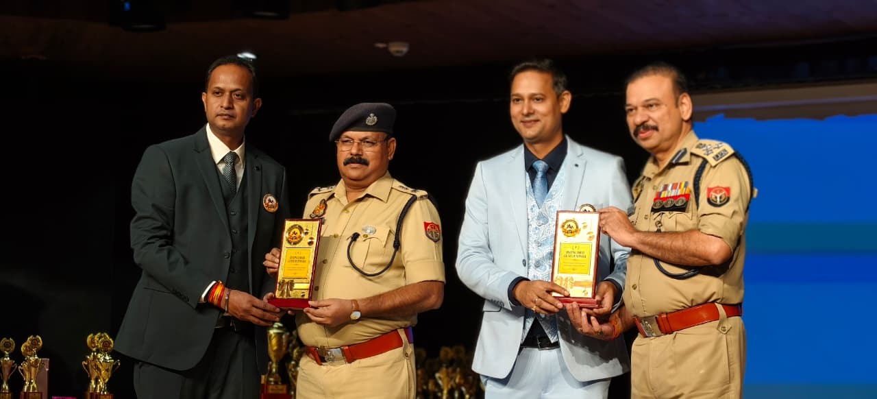 Award presentation on stage with senior police officers