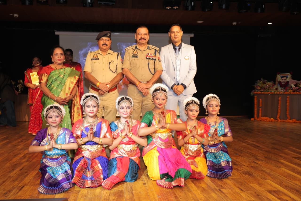 Young classical dancers in traditional costume with guests behind them